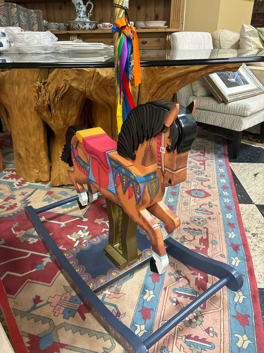 Colorful Child's Wooden Rocking Horse on Blue Base